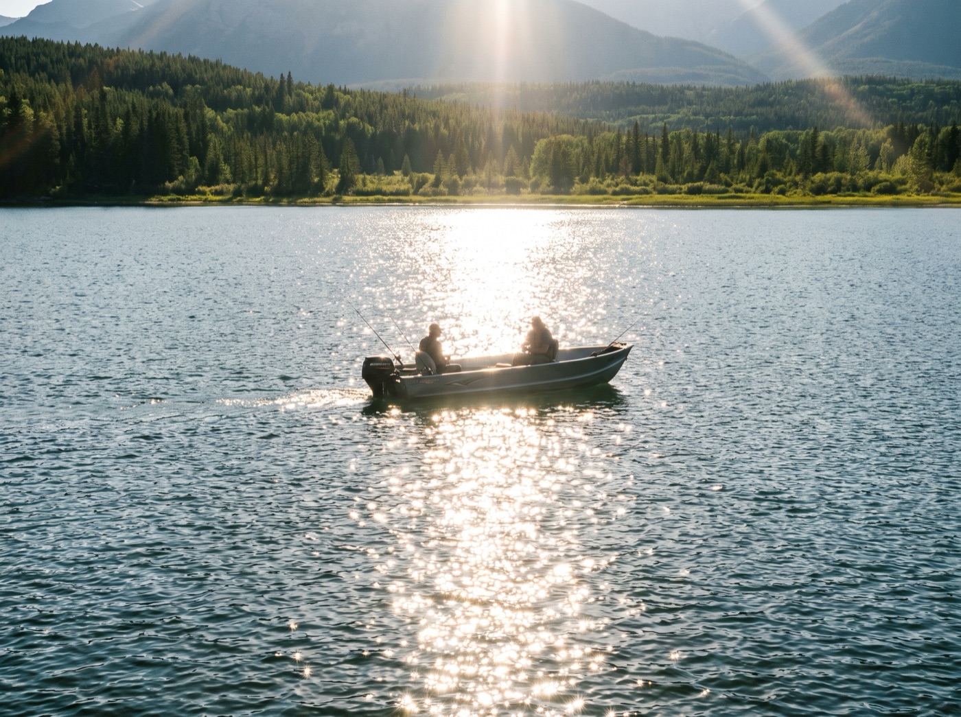Fishing boat silhouetted in a blinding sun-glitter path on open water
